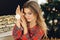 Close up of girl wears festive pajamas and take Christmas toy in hand at home