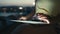 Close-up of a girl working on a tablet at sunset by the sea.