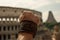 close-up of gladiator& x27;s clenched fist, with view of the coliseum in the background