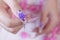 Close up glamorous woman hand manicure with long acrylic extension stiletto style painting sweet ombre pink glitter decorated with