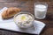 Close-up of glass bowl with oatmeal, glass of milk and croissant, healthy Breakfast
