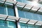 Close-up of glass building with windows reflected to the sky