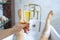 Close-up of a glass of champagne against the background of a relaxed male bathing in a bubble bath