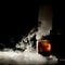 close-up of a glass of cold negroni drink in dark bar with dry ice effect