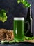 Close-up of a glass of green traditional Irish beer on St. Patrick`s Day. green hops