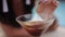 Close-up of glass of red Martini with orange slice, a girl drinking from a Martini glass on the background of the pool