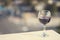 Close up of glass of red wine against the background of blurred town with bokeh