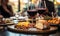 Close-up of a glass of red wine on a bar table with blurred people and charcuterie board in the background at a cozy wine tasting