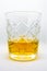 A close-up of a glass of wiskey isolated on a white background
