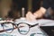 Close-up glasses is Asian young businessman of student holding a pen writing letter on paper at home