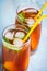 Close up of glasses with homemade ice tea, peach flavored. Freshly cut peach slices for arrangement. Top view.