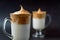 Close up of glasses of trendy dalgona coffee with milk on the dark background.