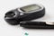 Close up of glucometer and blood sugar test stick