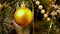 Close-up of gold Christmas balls hanging on artificial fir. Flashing yellow lights Christmas tree garland.