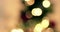 Close up of golden abstract blinking blurred Christmas tree lights bokeh on gold warm background, festive holiday