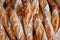 A close-up of golden brown baguettes lined up, showcasing the art of traditional French baking. Perfect for culinary