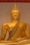 Close-up of golden Buddha in meditative pose