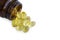 Close up golden color oil supplements in soft gel capsule,