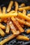 Close up of golden crispy french fries cooking in a deep fryer for a delicious snack