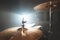 Close-up Golden cymbals Modern drum set prepared for playing in a dark rehearsal room on stage with a bright spotlight