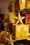 Close-up of golden gifts piled up in stack blurred in gold bokeh background - selective focus