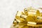 Close up Golden present box with big bow at bokeh white blur background