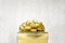Close up Golden present box with big bow at bokeh white blur background, Leave space on top to adding your content