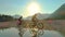 CLOSE UP: Golden sun rays shine on two travelers exploring the valley on ebikes.