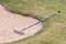 Close up of golf course sand bunker with a rake