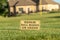 Close up of a golf course sign that reads Repair Ball Marks On Green