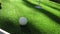 Close-up of golfer using putter to sink short putt into hole