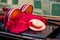 A close up of a gondola with oars, gondolier hat and red blanket in Venice, Italy