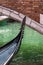 Close up of Gondola\'s Iron Prow and Antique Bridge in Venice