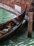 Close up of Gondola\'s Iron Prow and Antique Bridge in Venice