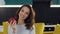 Close up of gorgeous joyful lady with wavy hair looking at camera with redapple in her hand on the cuisine background