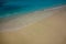 CLOSE UP: Gorgeous turquoise ocean water washes the pristine white sand beach