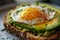 A close-up of a gourmet avocado toast topped with a perfectly fried egg Healthy Breakfast. Egg and Avocado Toast