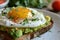 A close-up of a gourmet avocado toast topped with a perfectly fried egg Healthy Breakfast. Egg and Avocado Toast