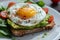 A close-up of a gourmet avocado toast topped with a perfectly fried egg Healthy Breakfast. Egg and Avocado Toast