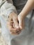 close up granddaughter holding grandmothers hand