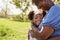 Close Up Of Granddaughter Hugging Grandmother In Park