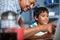 Close up grandfather assisting grandson using laptop