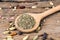 Close up of granulated basil on a wooden cooking spoon