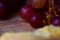 Close-up of grapes on a wooden board, shallow depth of field. Wine appetizer