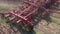 A close-up of grass collection equipment. The farmer collects plants for feed cattle, forage. Green field in summer