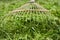 Close up of a grass rake,lie on a pile of grass rake in the garden