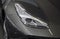 The close up of gray sport car right headlight.