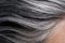 Close up of gray streaks in dark hair