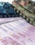 Close up green and blue tank toy placed on euro banknotes pile. business and economy war. new world war from business and economy