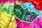 Close-up green carnival mask, venetian mask place on the colorful fluffy, Top view